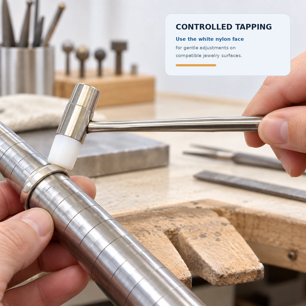 Jeweler using white nylon head hammer on a steel ring mandrel for controlled tapping and ring resizing on the workbench